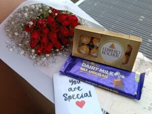 20 ROSES WITH BABY BREATH , A LARGE CADBURY & FERRERO ROCHER CHOCOLATES