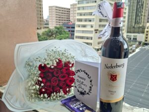 RED ROSES, RED WINE WITH A CHOCOLATE BAR
